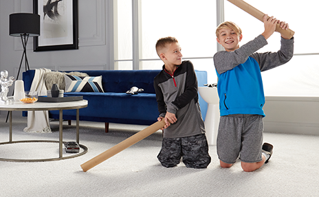 durable beige carpet two boys play in a stylish living room